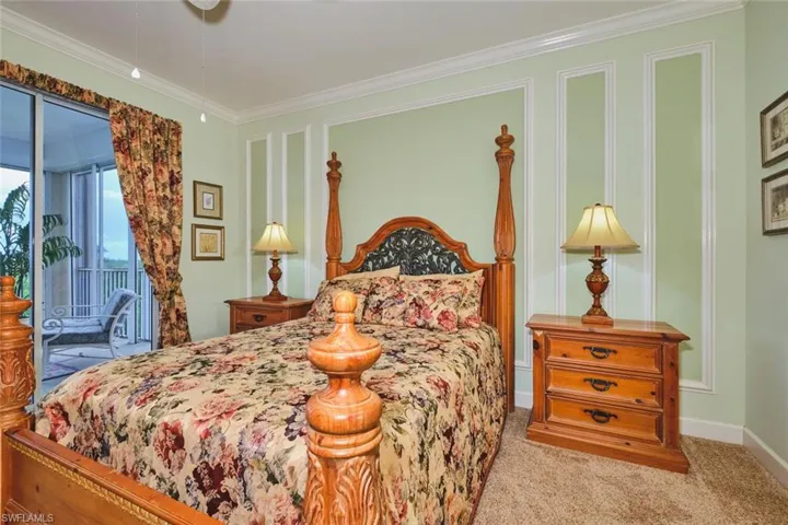 Bedroom with carpet floors, ornamental molding, and access to exterior