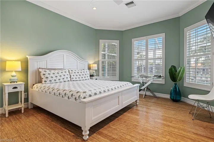 Bedroom with crown molding and light wood-type flooring