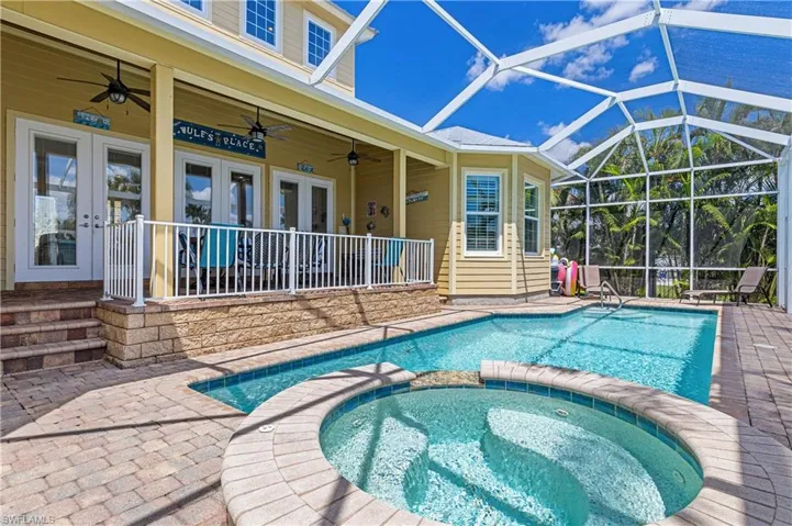 View of swimming pool featuring french doors, a patio area with ceiling fan