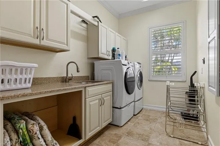 Laundry-room with sink, washing and dryer, crown molding, and cabinet space