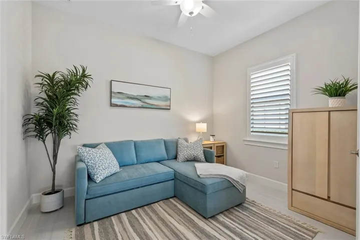Den/Office/guest room featuring sofa bed, and ceiling fan
