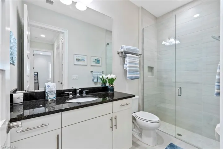 Guest Full bath featuring vanity and a stall shower