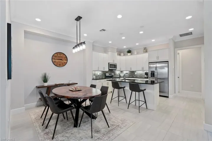 Dining room featuring crown molding and recessed lighting