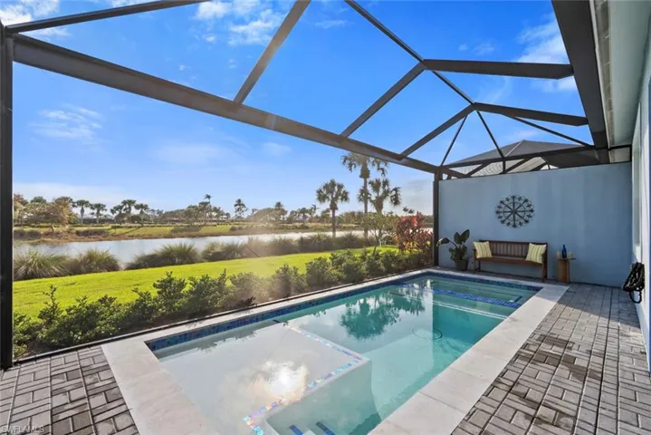 Swimming pool and hot tub with afternoon sun.