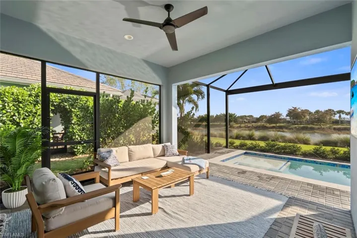 Patio with a ceiling fan and a water view.
