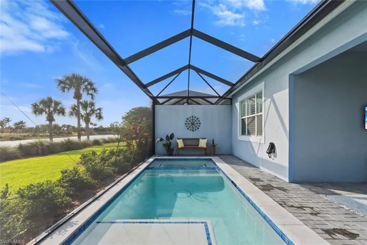 View of swimming pool featuring a picture screen enclosure.