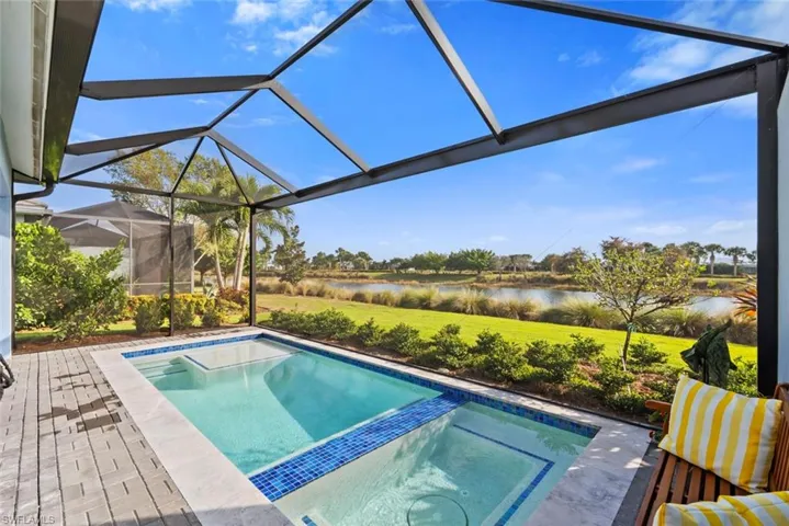 View of swimming pool featuring a water view of pool with connected hot tub
