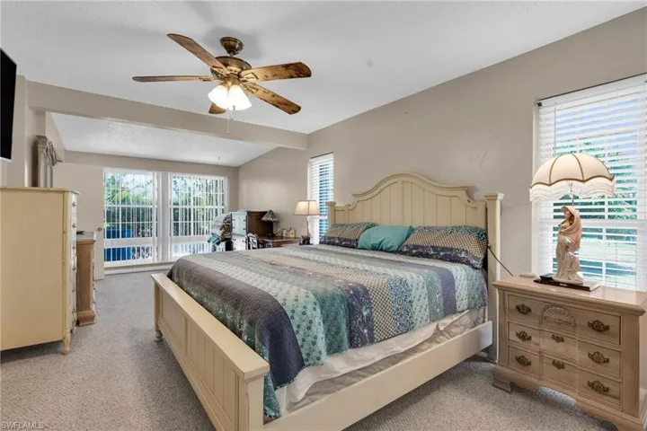 Bedroom #1 Master with light colored carpet and a ceiling fan