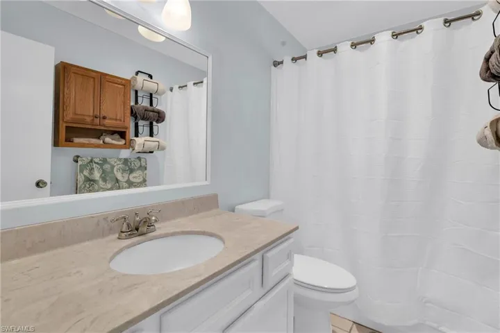 2nd bath Full bathroom with toilet, vanity, and a shower with shower curtain