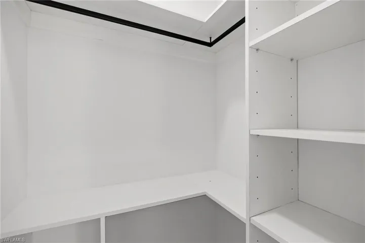 Custom closet system featuring white shelving