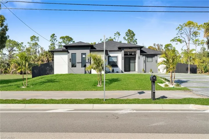 Prairie-style home featuring stucco siding, driveway, and an attached garage