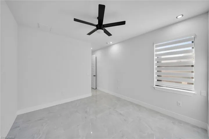 Spare room with recessed lighting, ceiling fan, and radiator