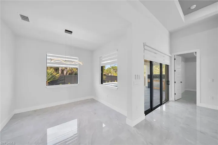 Unfurnished room featuring baseboards and light marble finish floors