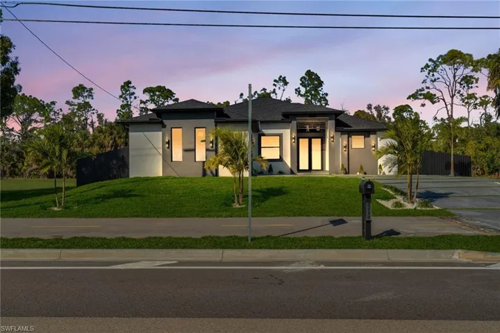 Prairie-style home with stucco siding and driveway