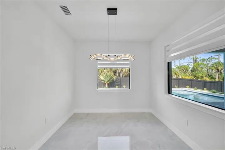 Unfurnished dining area with baseboards