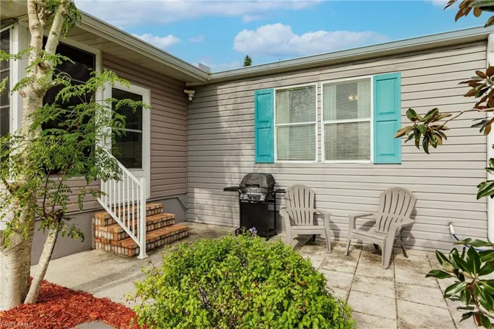 View of exterior entry with a patio area