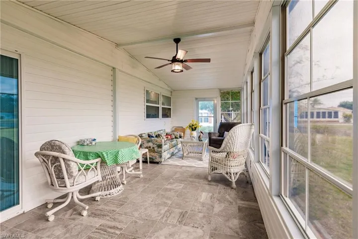 Sunroom / solarium featuring ceiling fan and vaulted ceiling