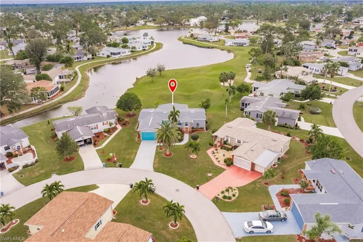 Birds eye view of property with a water view