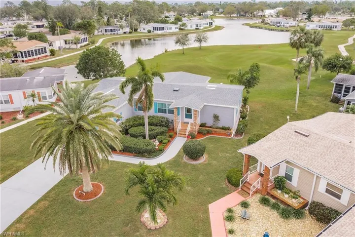 Birds eye view of property with a water view