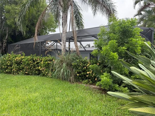 View of grassy yard featuring a lanai