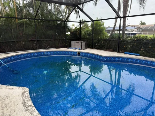 Outdoor pool featuring a lanai