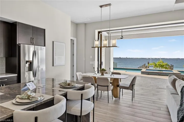Dining area with a water view and light wood-style floors