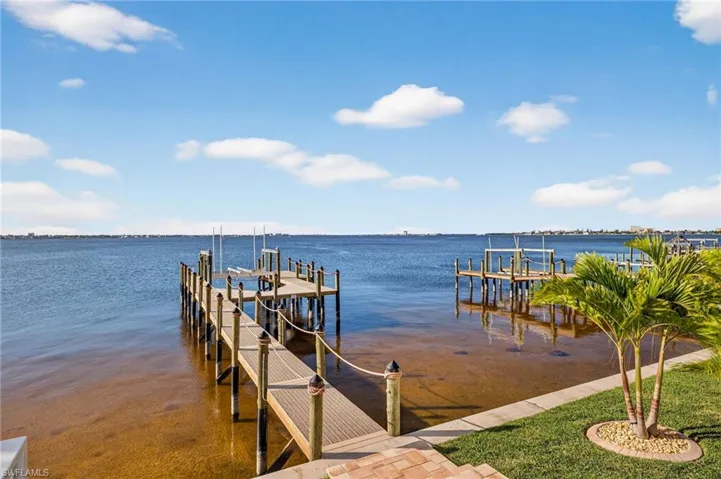 Dock area with boat lift and a water view