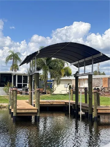 Dock with a water view and a yard, back of home