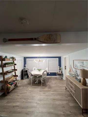 Dining area featuring wood finished floors and a chandelier, direction of photo taken from the living room