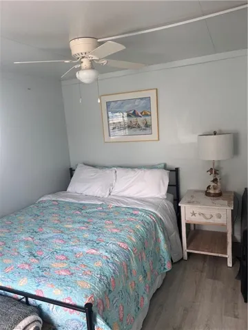 Guest bedroom with laminate floors and ceiling fan