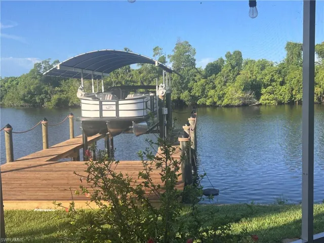 Dock area with a water view and boat lift