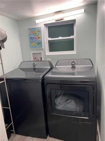 Washroom featuring full sized washer and clothes dryer