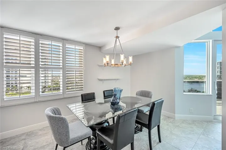 Dining area featuring a chandelier and baseboards