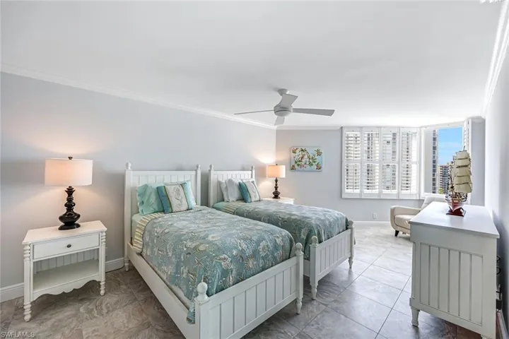 Bedroom featuring crown molding and a ceiling fan