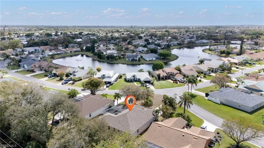 Aerial view of property's location featuring a large body of water and nearby suburban area