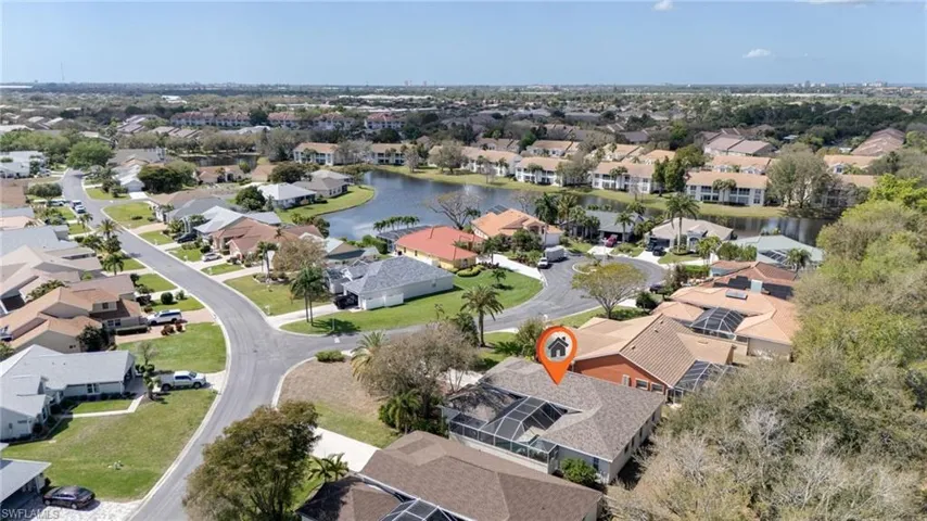 Aerial overview of property's location featuring a nearby body of water and nearby suburban area