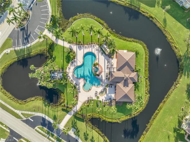 Bird's eye view of a nearby body of water and a pool
