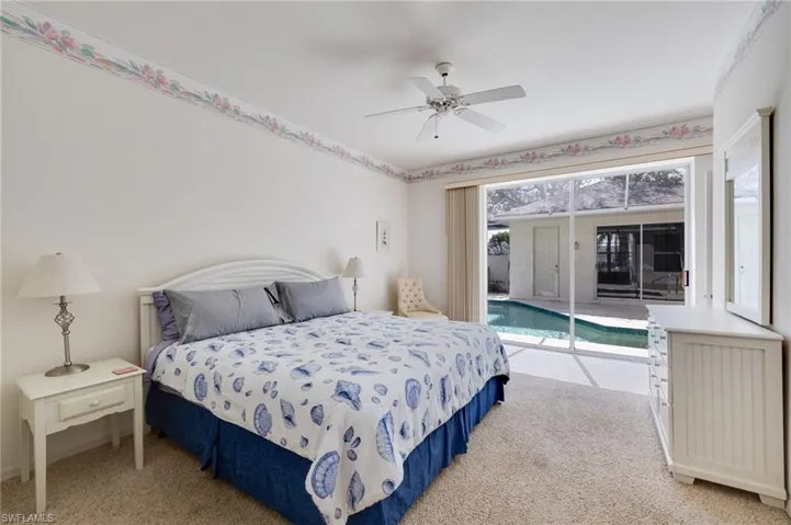 Bedroom featuring access to exterior, light carpet, and a ceiling fan