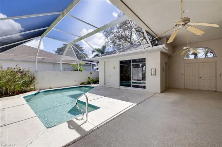 View of pool with a sunroom, patio surround, and a lanai