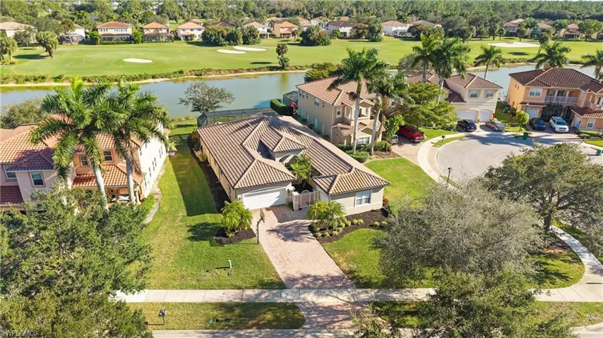 Aerial view of residential area featuring a large body of water and a golf club