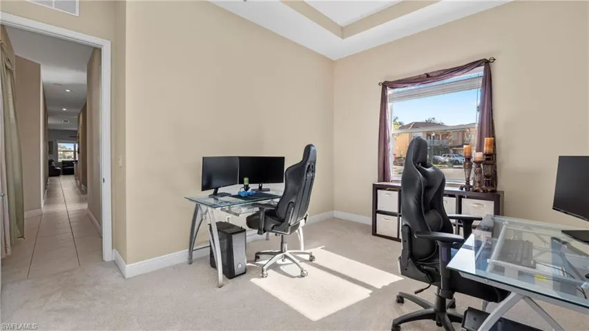 Office featuring light carpet and plenty of natural light
