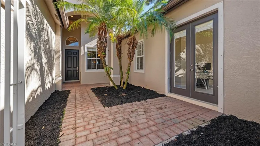 Entrance to property with stucco siding and french doors