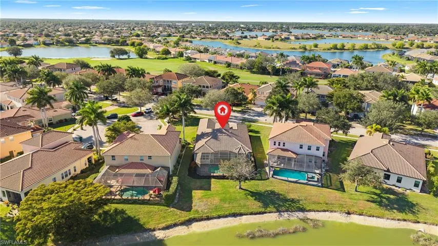 Aerial perspective of suburban area featuring a nearby body of water