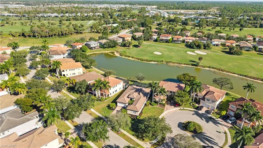 Aerial view of residential area with a large body of water and a golf club
