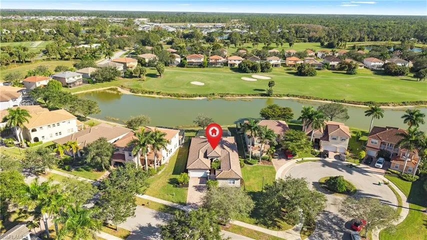 Aerial view of residential area with a large body of water and a golf course