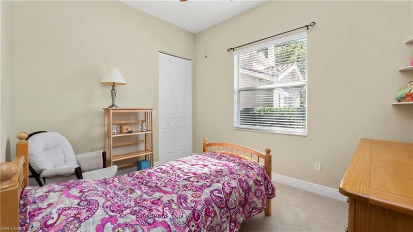 Carpeted bedroom featuring baseboards and a closet