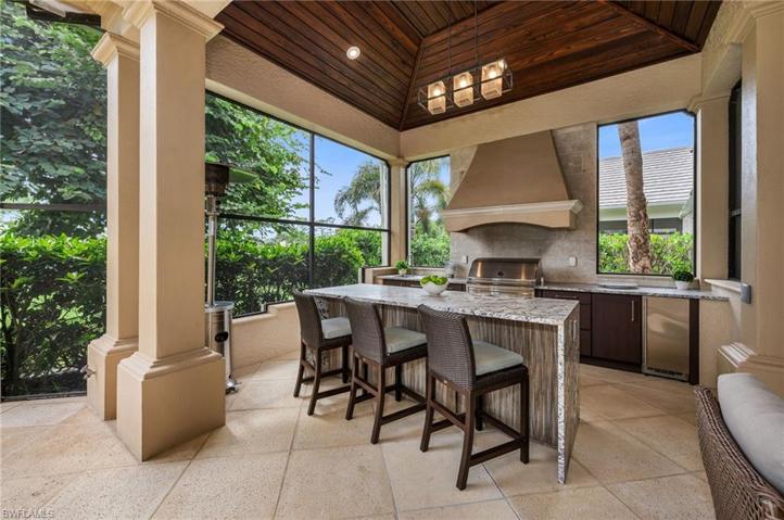 The outdoor kitchen has been redone, with a Lynx grill, refrigerator and a leather-finish granite waterfall island.  Wine anyone?