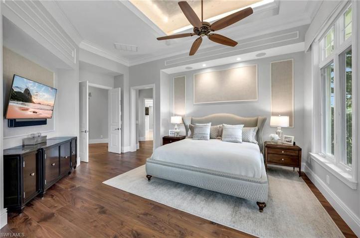 High ceilings, detailed walls, gorgeous wood floors, and automated window treatments make this room so welcoming.