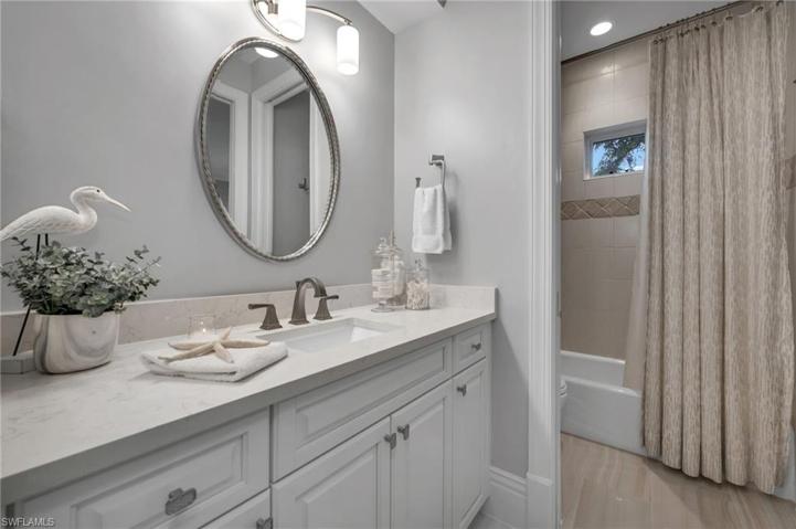 The guest bath has new cabinetry, hardware, fixtures, quartz counters, lighting and it is ready for company!