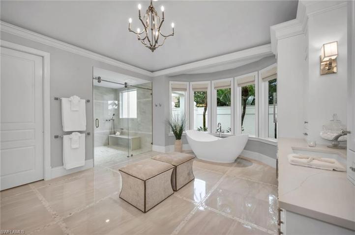 This incredible bath measures up to any 5-Star Hotel bathroom, with it's custom cabinetry, inlaid mother-of-pearl tiles, quartz counters, and so much more detail.